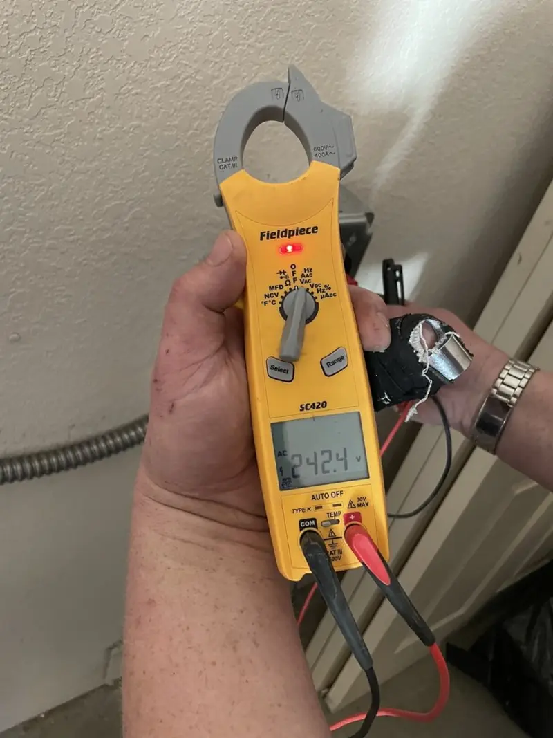 Voltage testing with clamp meter during Outlet Installation in Champion